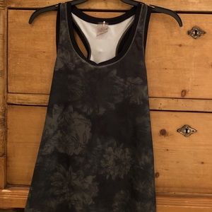 Green tank top with black flowers on it